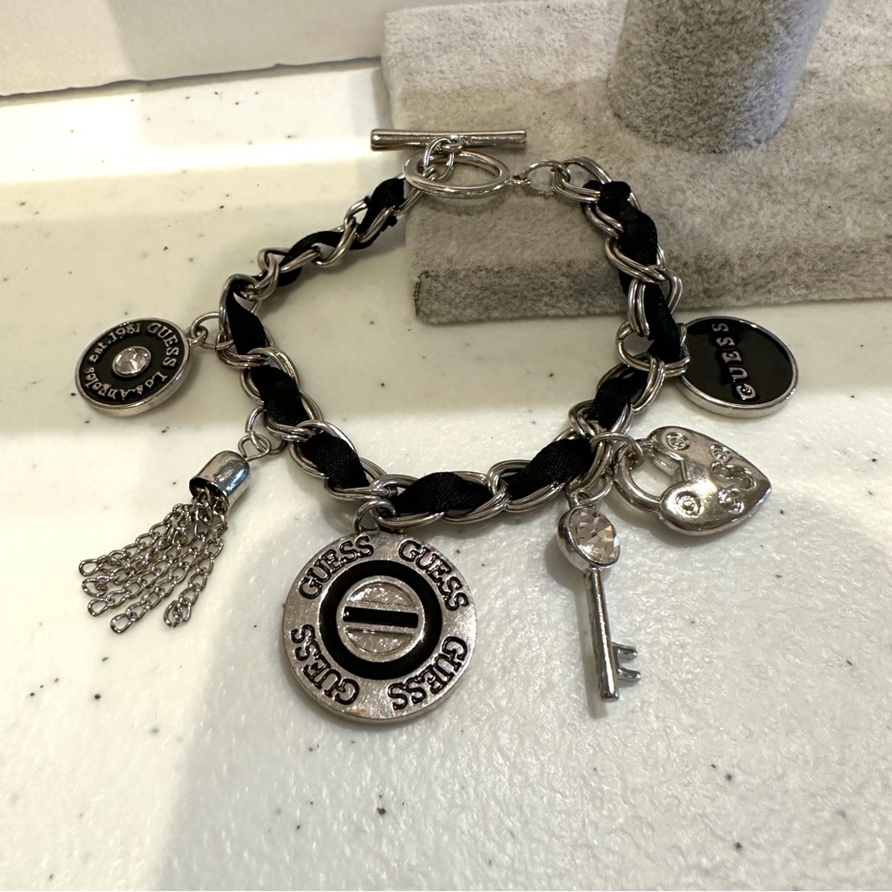 GUESS charm style Bracelet silver tone, black accents, heart, key, logo charms